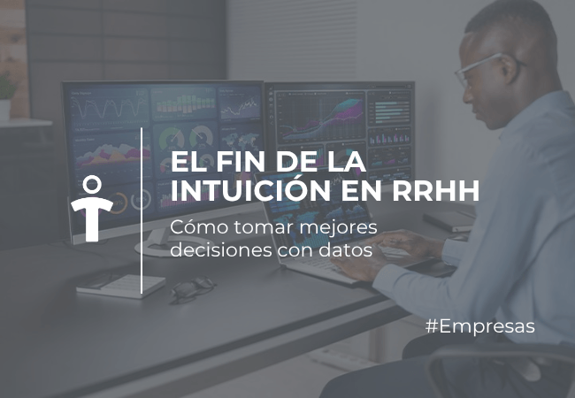 EMPRESAS Person at a desk using multiple monitors filled with charts, illustrating data‑driven HR decisions